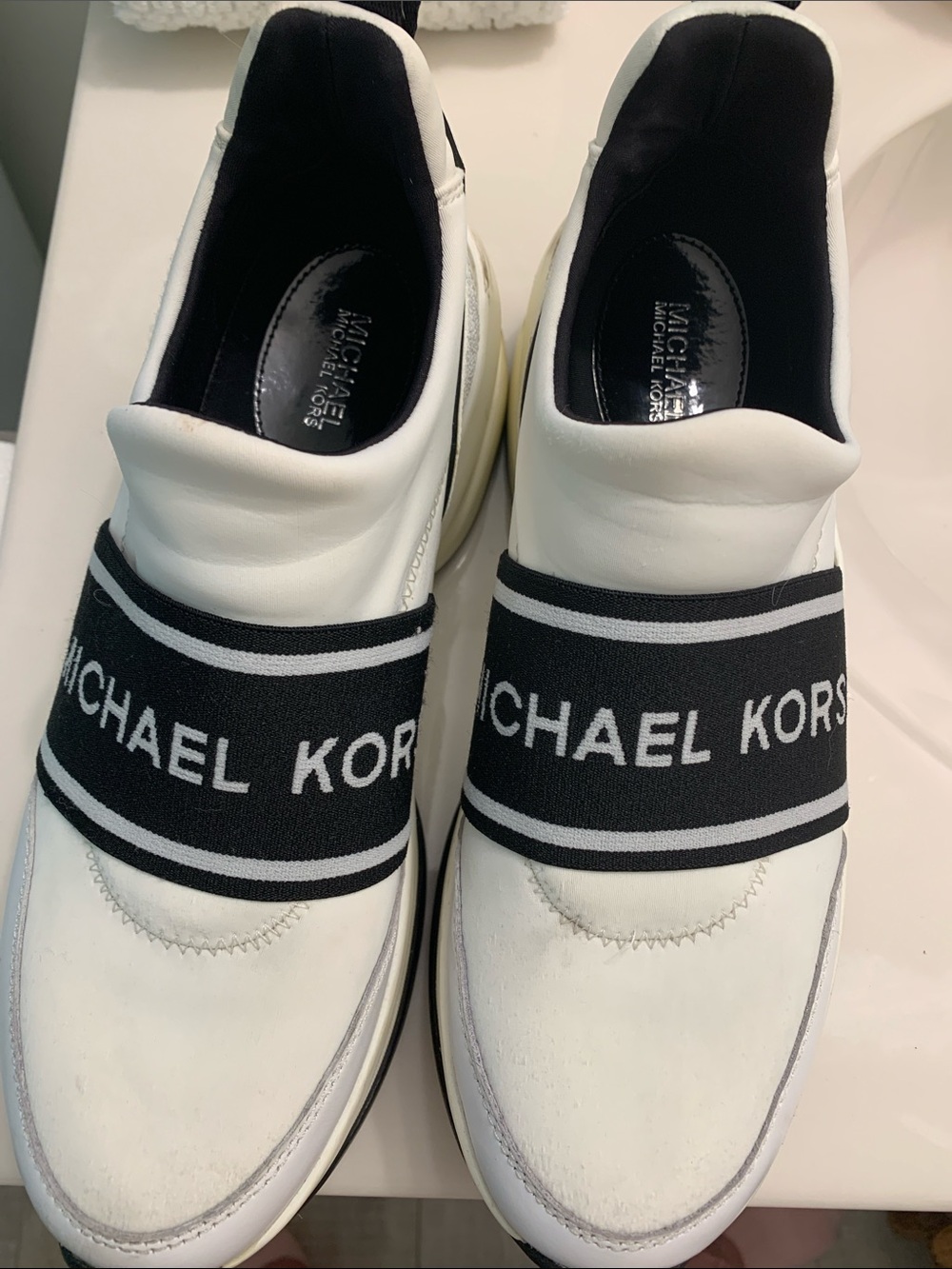 Michael Kors White Slip-On Sneakers with Black Logo Strap